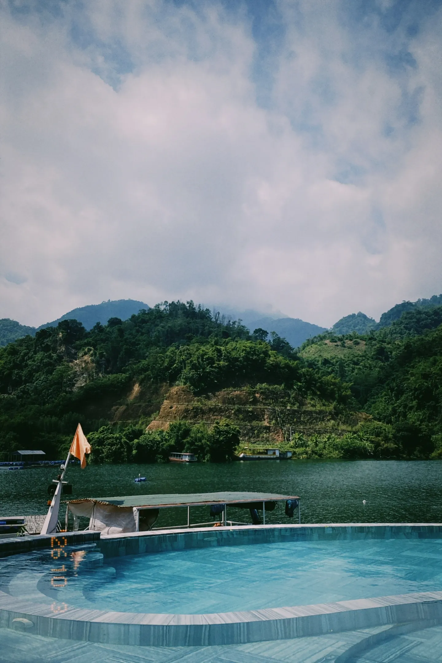 A lake among green mountains in northern Vietnam, seen from a boat